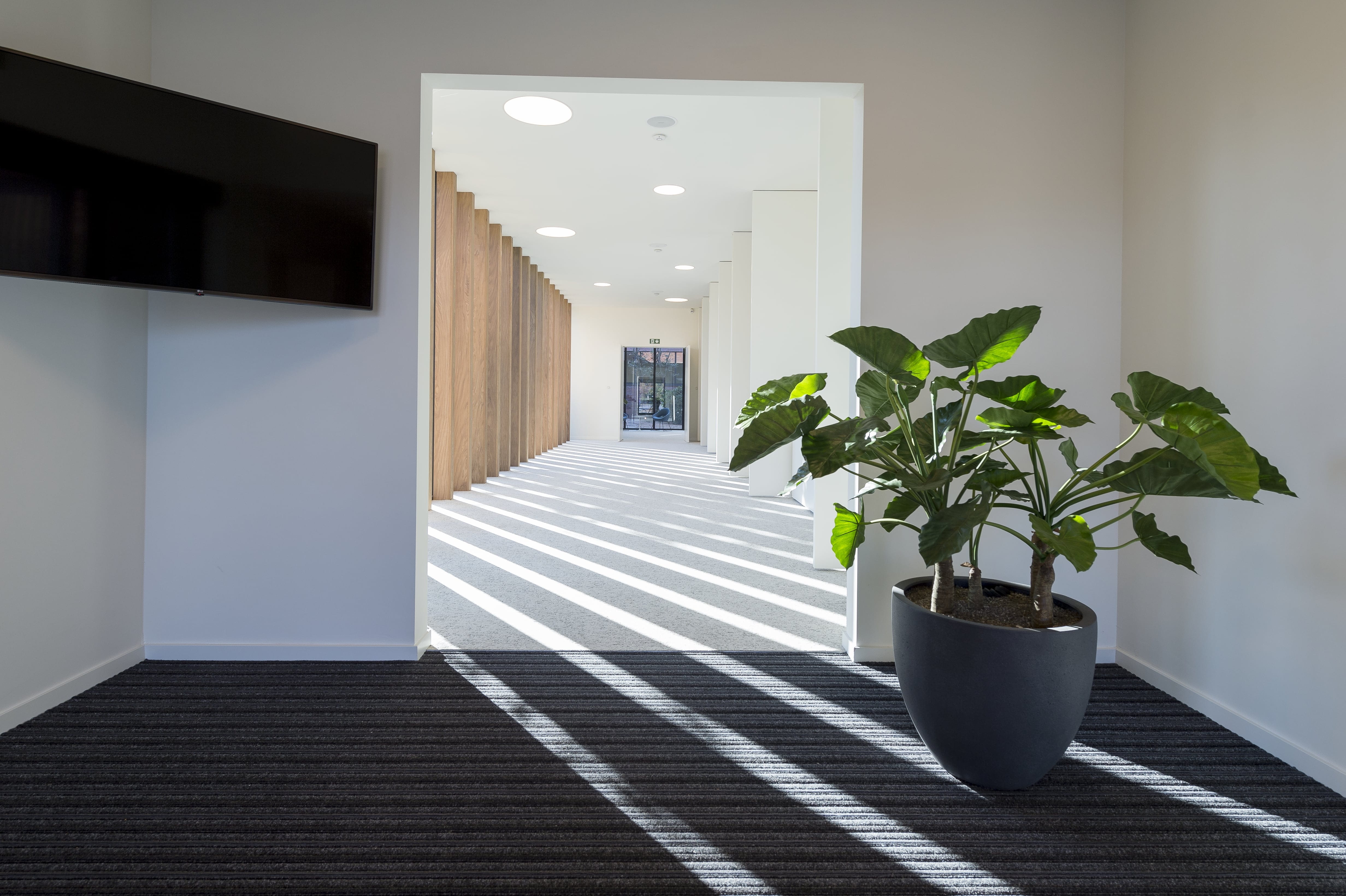 Lange gang met schaduwspel door de binnenvallende zon